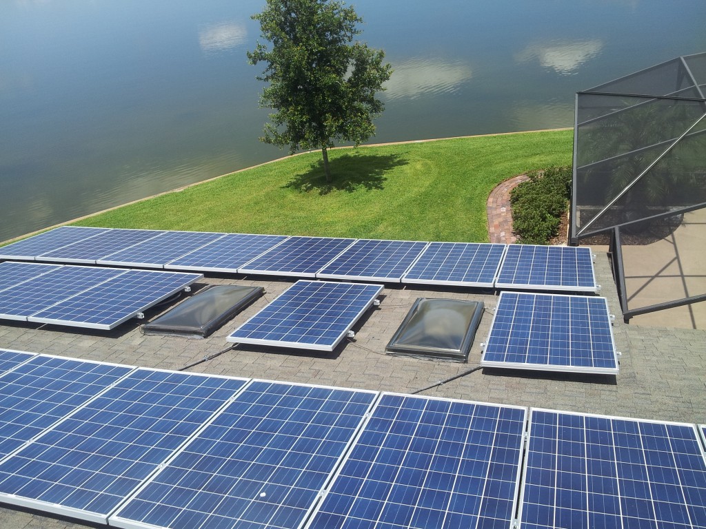 pv solar panel installed on Orlando home rooftop next to lake