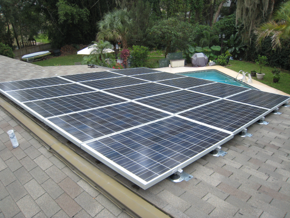 solar pv panels installed on family home in Orlando Florida with pool in background