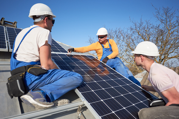 Installing solar photovoltaic panel system on roof of house in Orlando Florida