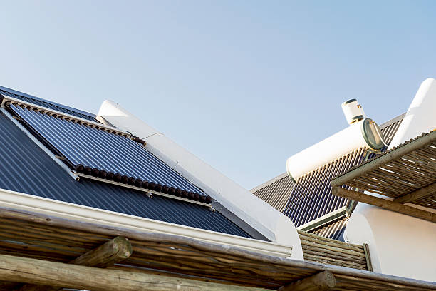 Solar water heater tank and panels installed on roof of property