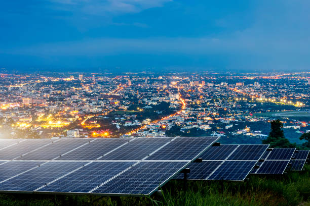 Solar panel with city night architecture electric energy light background,clean Alternative power energy concept.